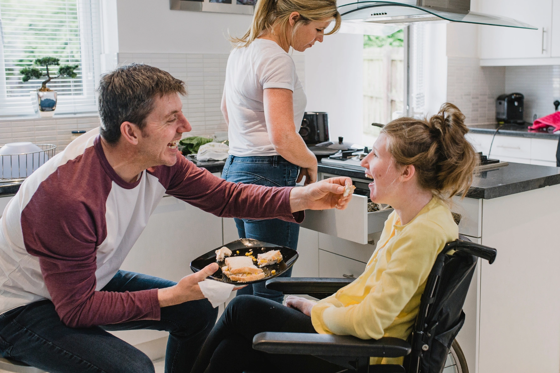 Father Feeding Disabled Daughter at Home
