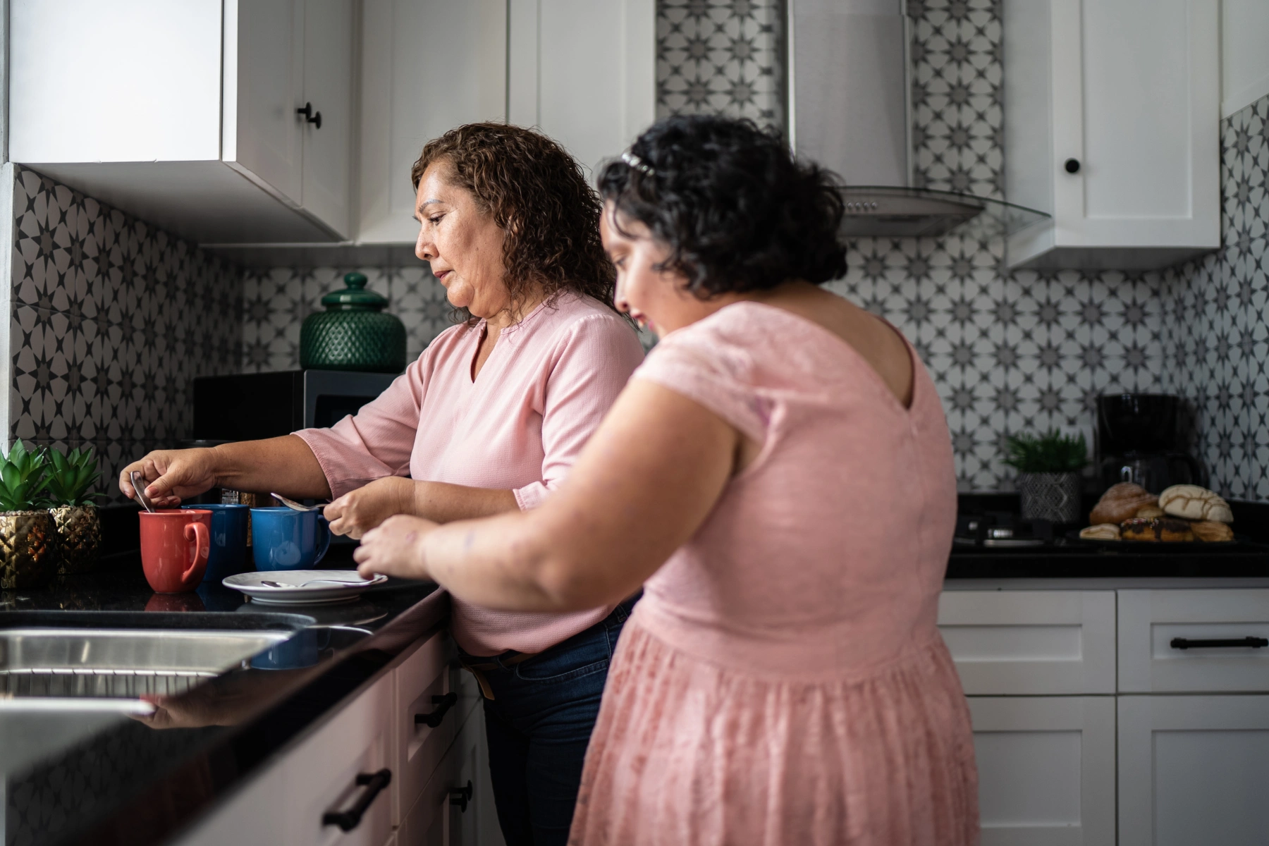 Mother and disabled psychomotor Intellectual disability making a coffee at home